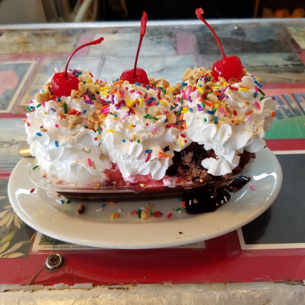 Banana Split with banana, three types of ice cream, whipped cream, nuts, cherries and sauce.